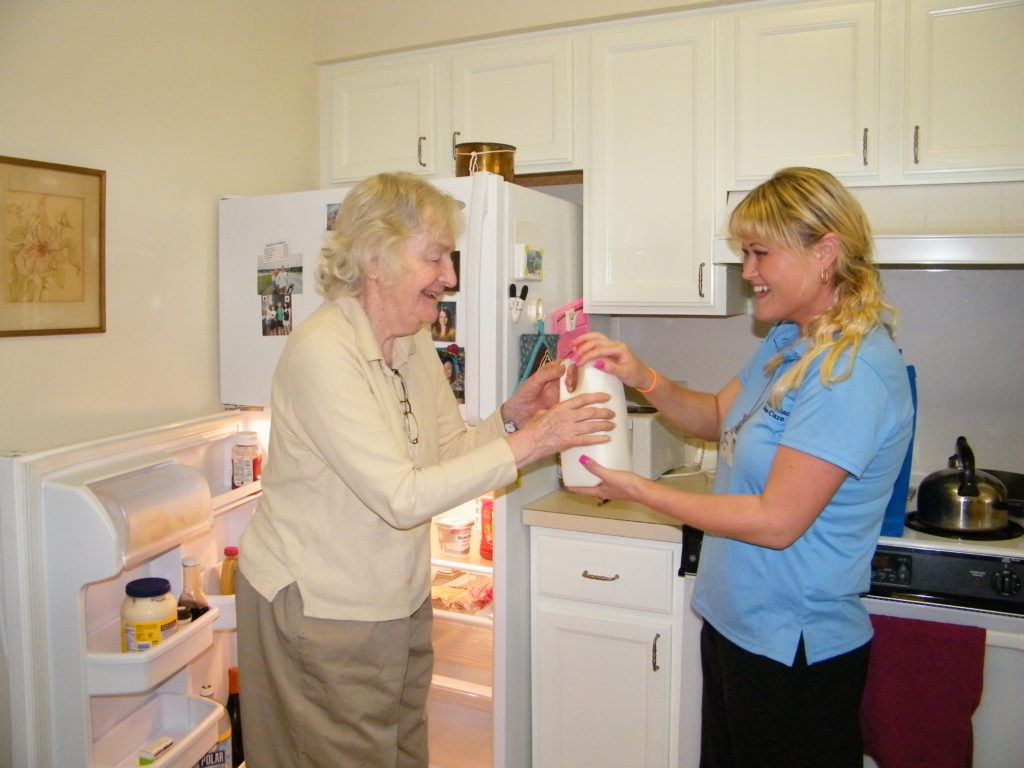 Resident and aide in kitchen