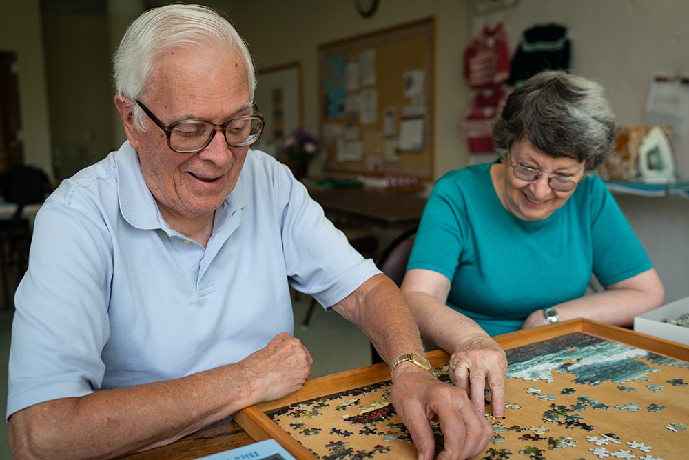 Residents work on a puzzle